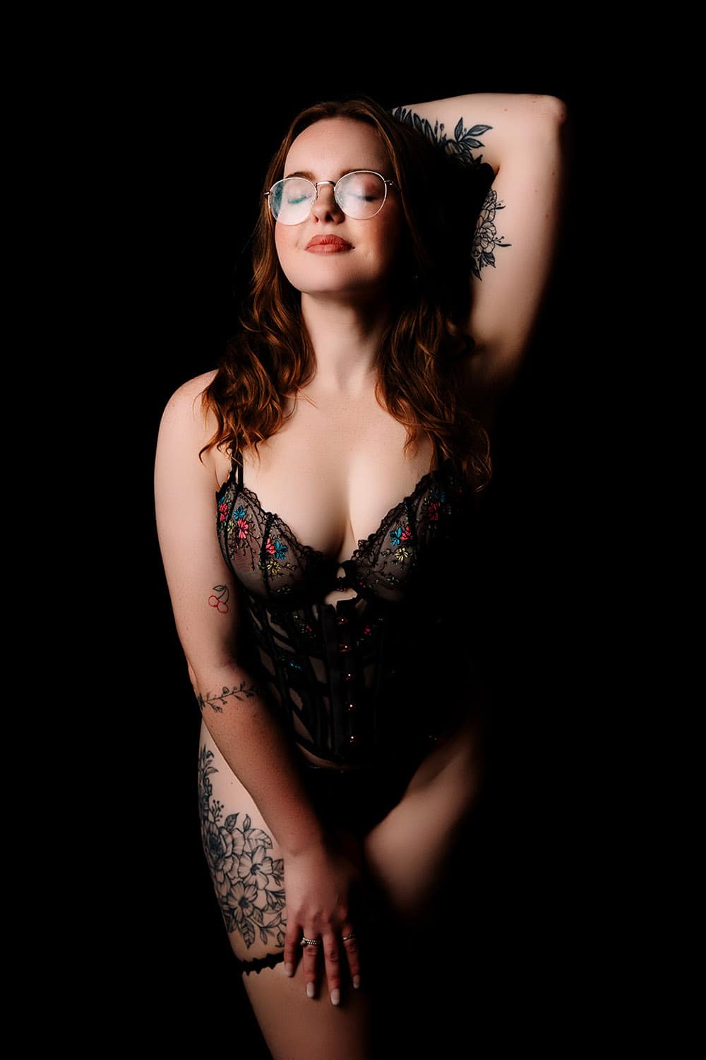 Soft natural light boudoir portrait with relaxed pose and neutral tones